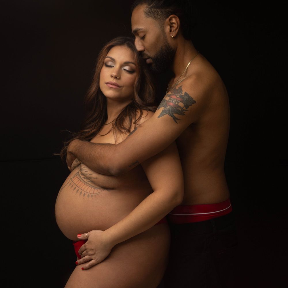 Beautiful photo of an expectant couple.  Photographed in a photo studio in Long Island.