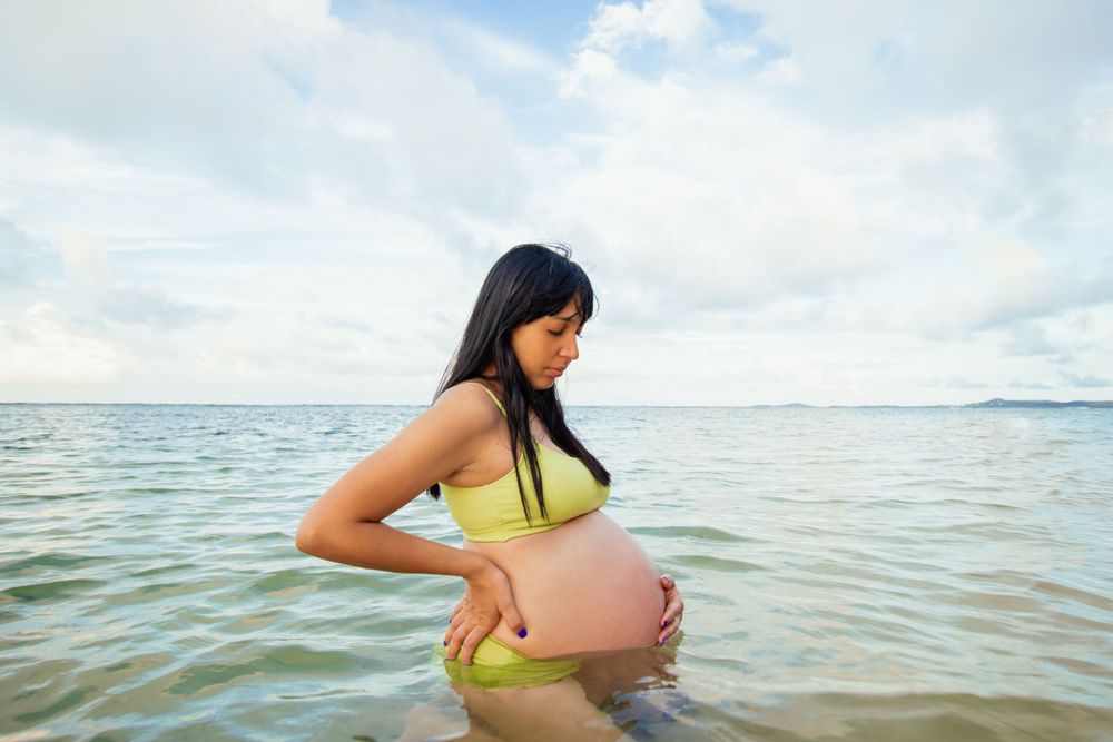 Destination mother and child photo shoot.  Photo was captured in Puerto Rico.  Mother is showing her pregnant belly