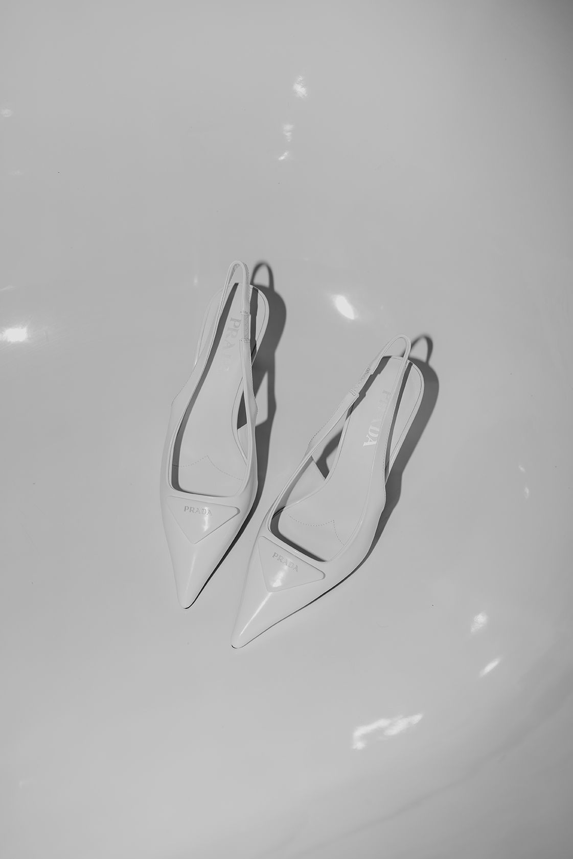 White prada bridal shoes photographed in a fashion forward editorial style.