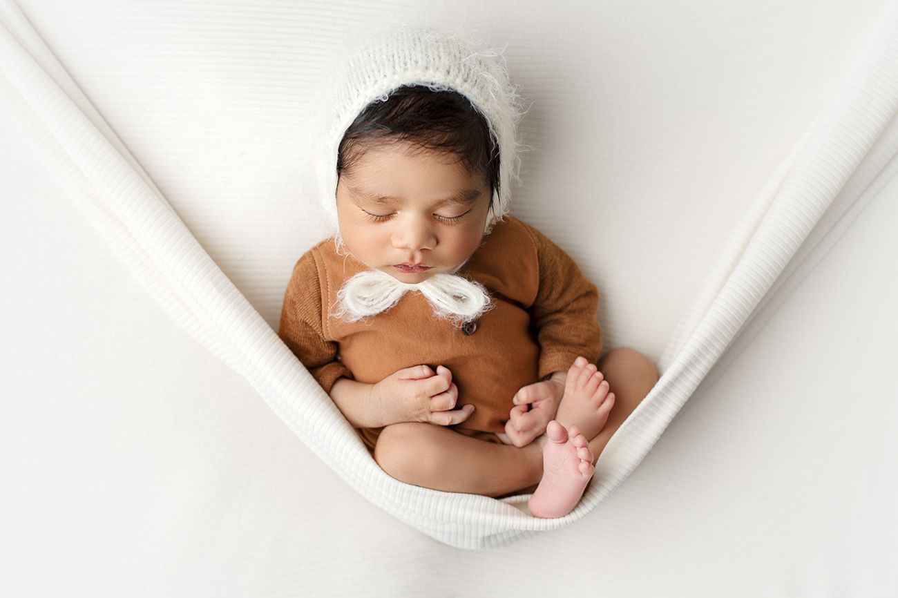 Professional newborn photography Springfield Lakes – baby boy sleeping in white hammock, affordable portraits for Ipswich, Logan and Forest