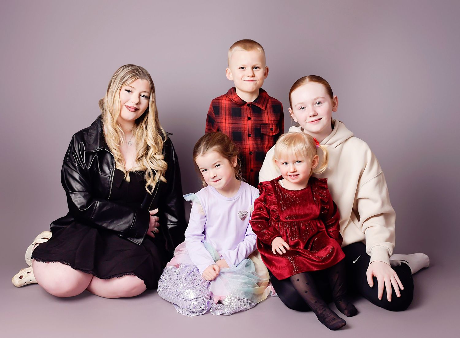 cousins photography by Nicola in Woodside, capturing natural connection, fun and timeless family bond in a relaxed studio portrait