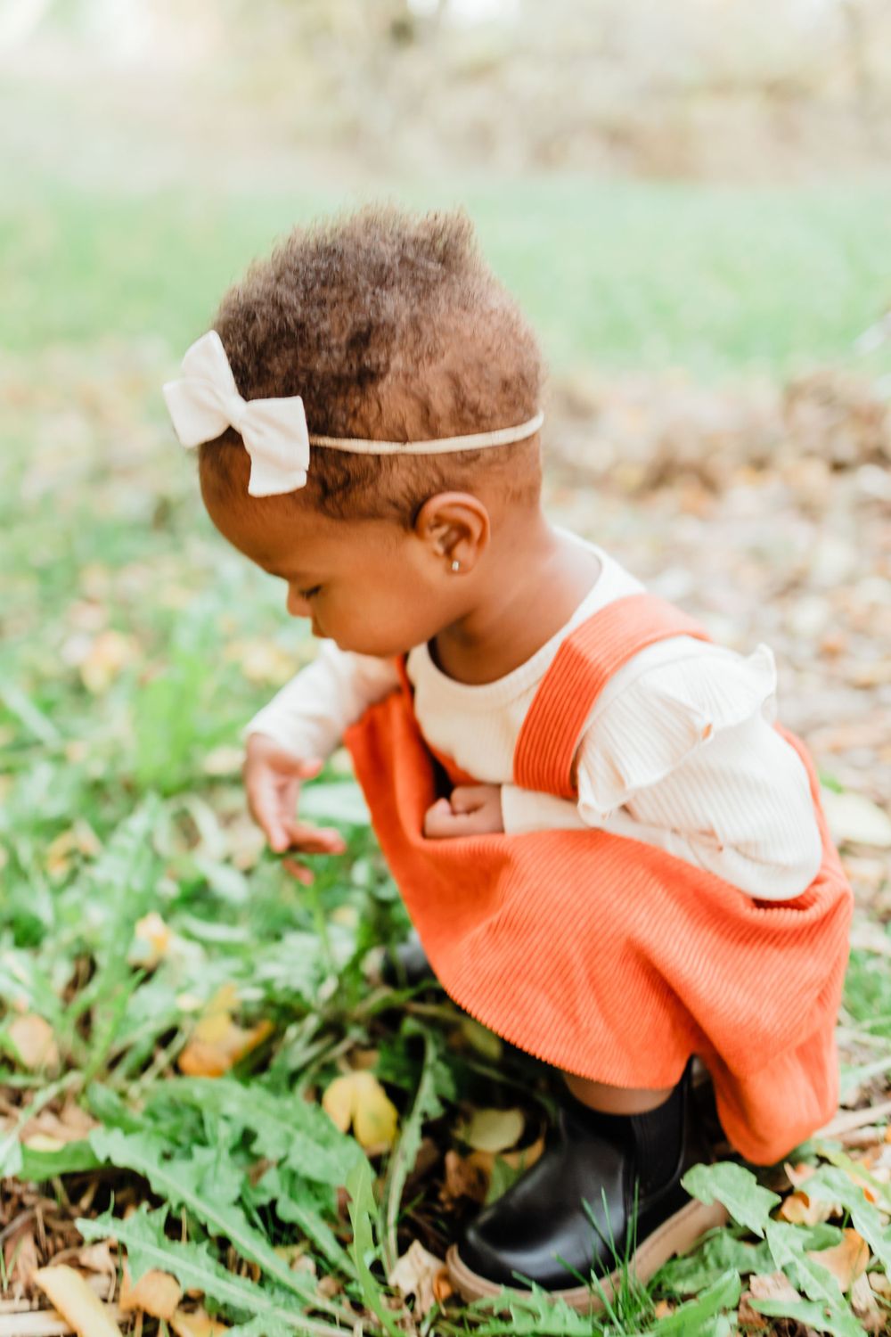 Baby Girl Crouching in Orange Dress