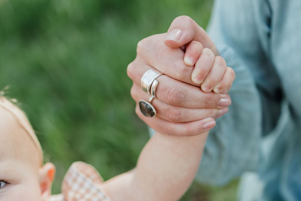 Close up Mom Holding Daughters Hand