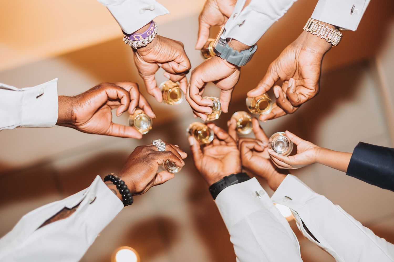 Hands with wedding rings form a circle showing off their new jewelry in a celebratory moment.