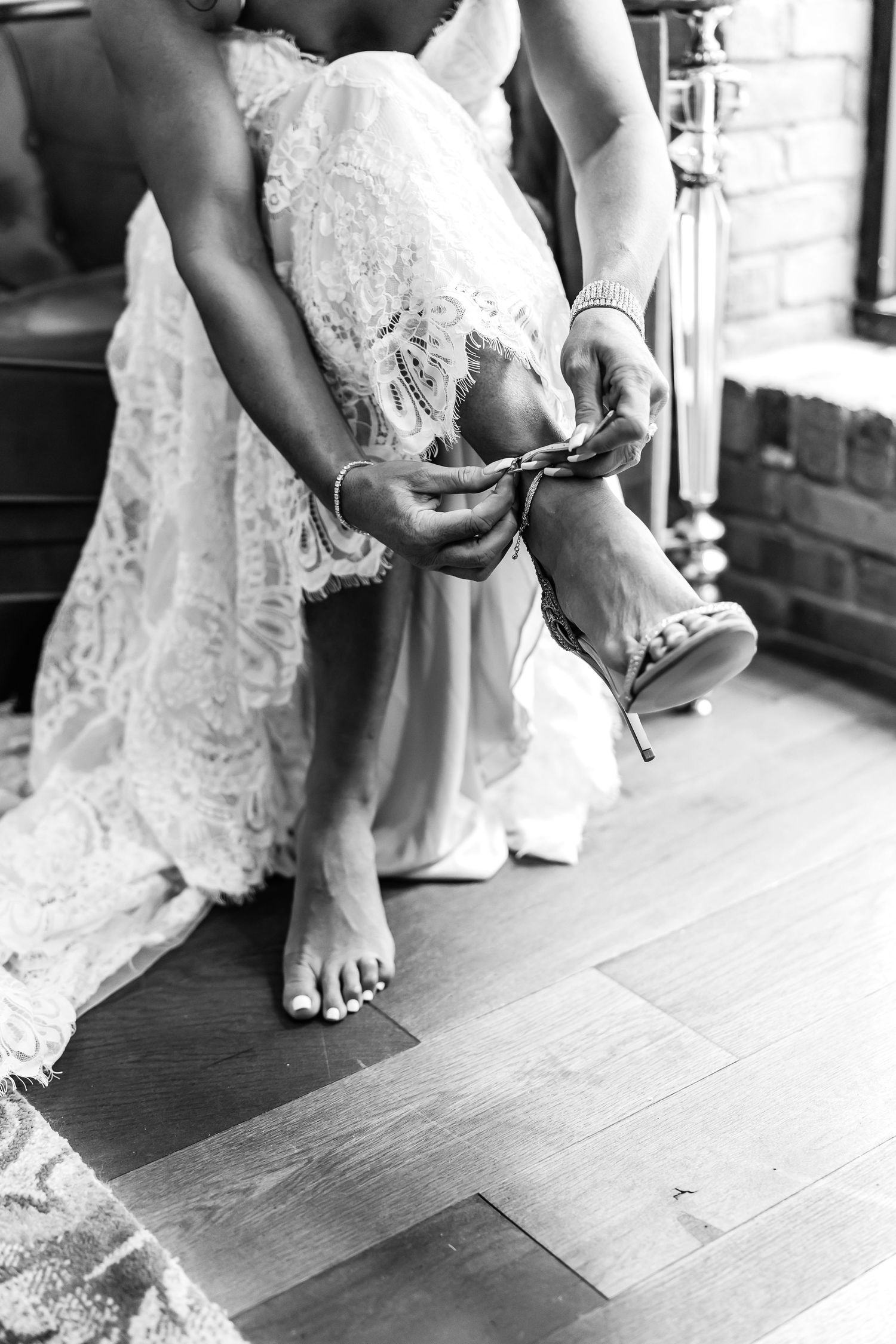 Close-up shots of bare feet with white lace dress hem showing preparation moments before a wedding ceremony.