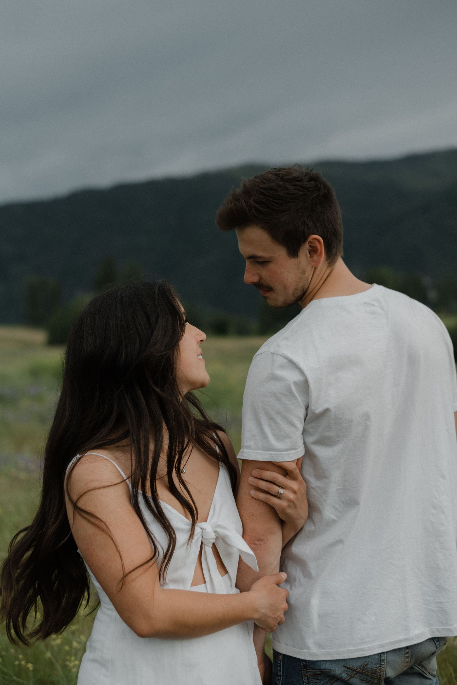couple outside looking at each other lovingly