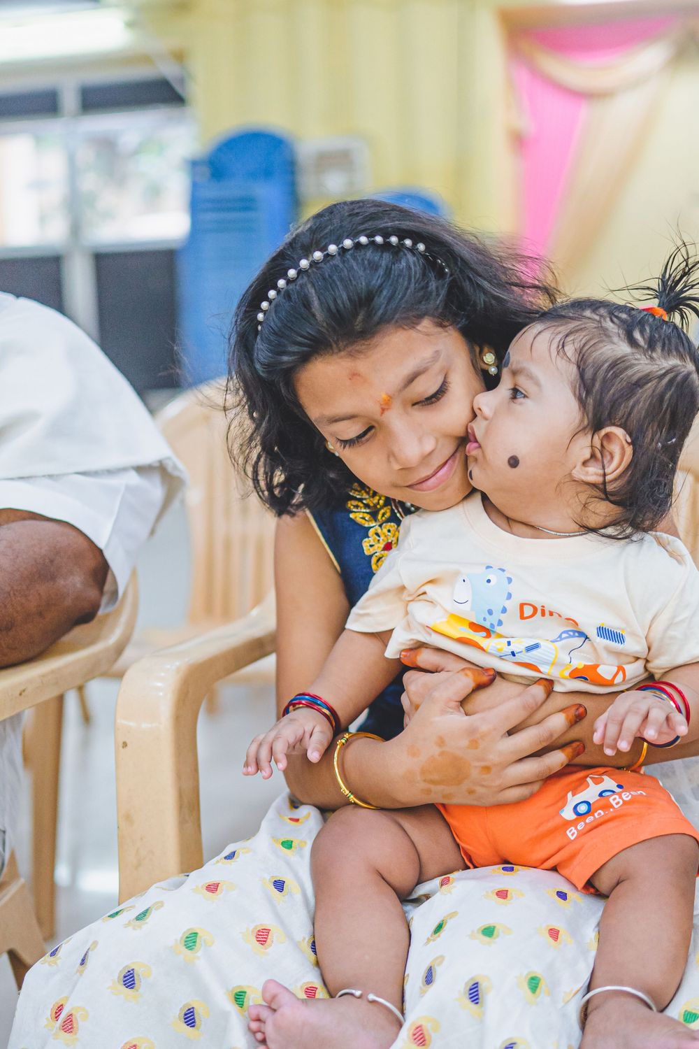 Tender moment shared between parent and child sitting in a chair.