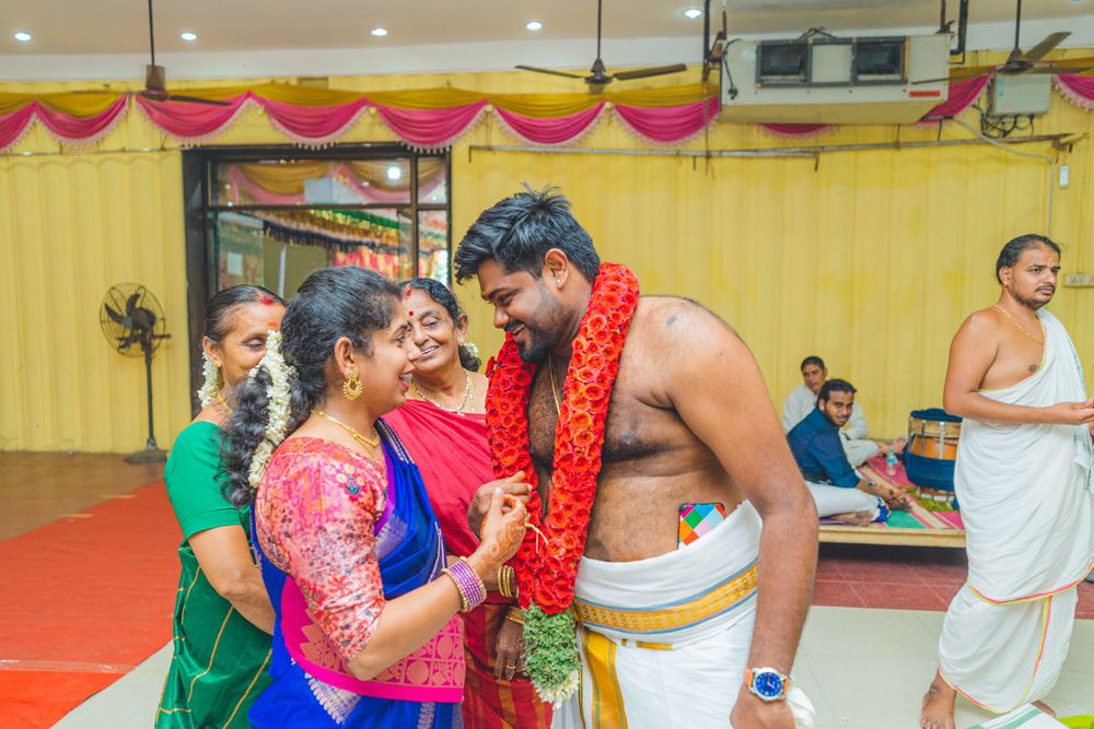 Traditional Indian ceremony showing participants in festive attire with garlands during celebrations.