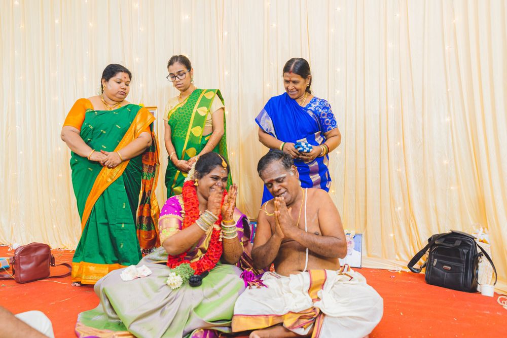 Traditional Indian ceremony with participants in colorful saris gathered for ritual proceedings.