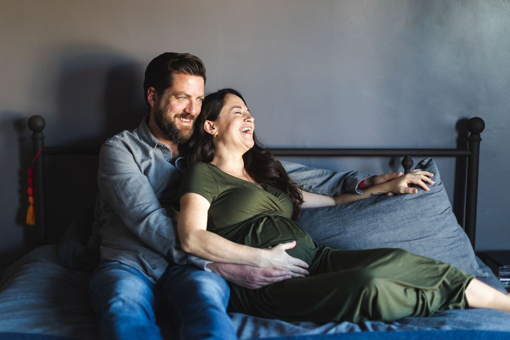 Cozy lifestyle photography session on a comfortable sofa in moody lighting.