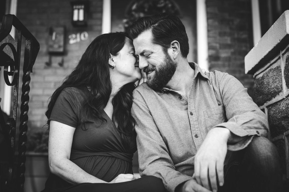 Intimate indoor photography session with soft natural lighting and casual atmosphere.