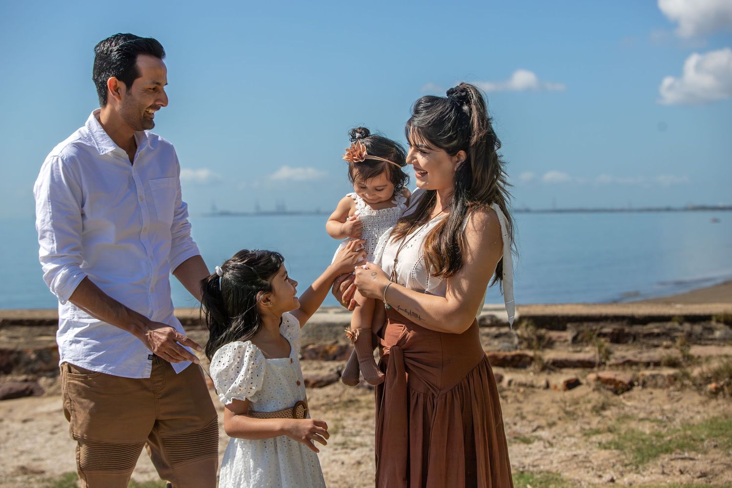 Happy family spending time together on a scenic coastal overlook.