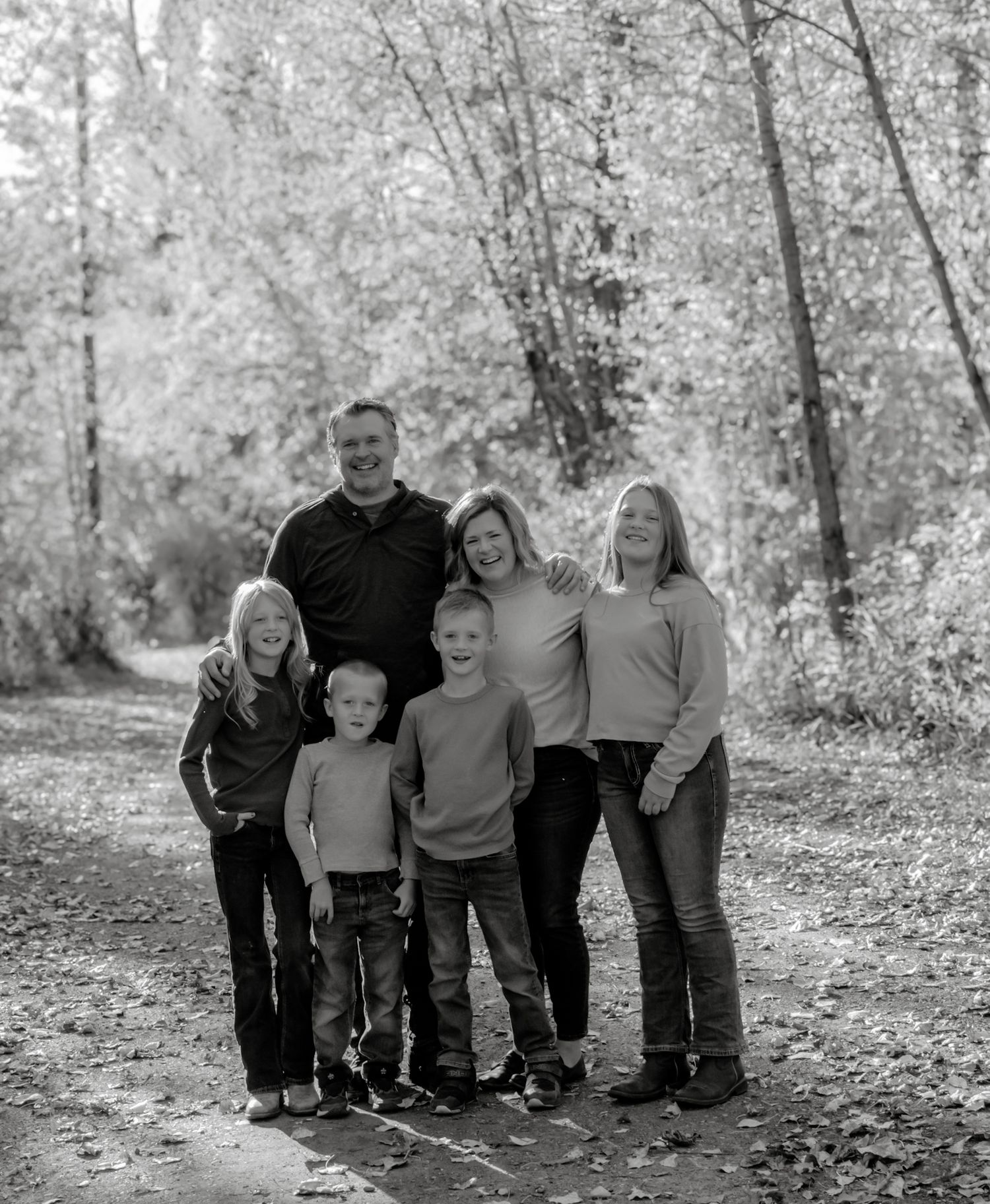 Heartwarming family portrait outdoors in Northern British Columbia, photographed by Captured Moments Photography