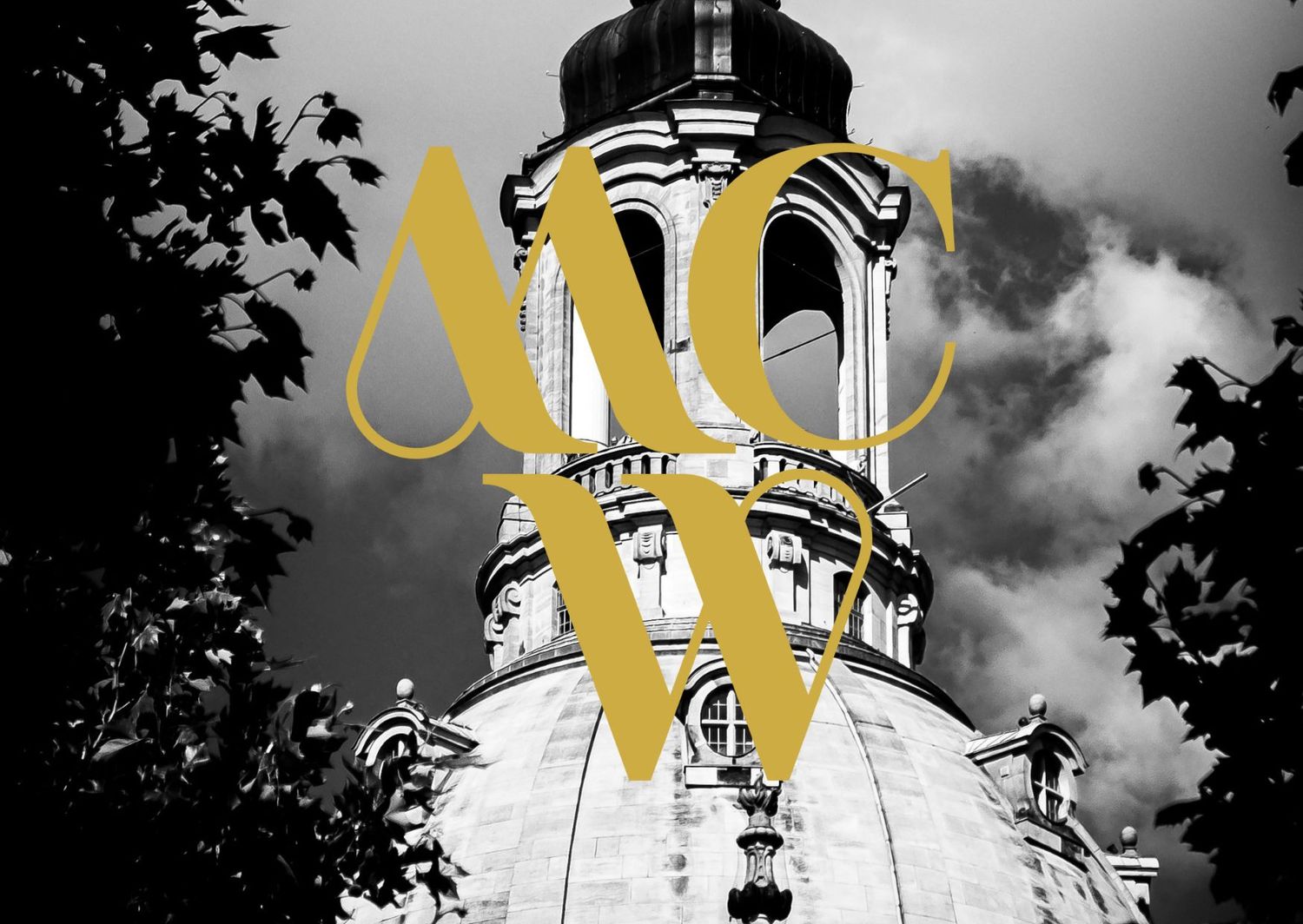 Black and white architectural photo of ornate church tower with gold MCW monogram overlay.