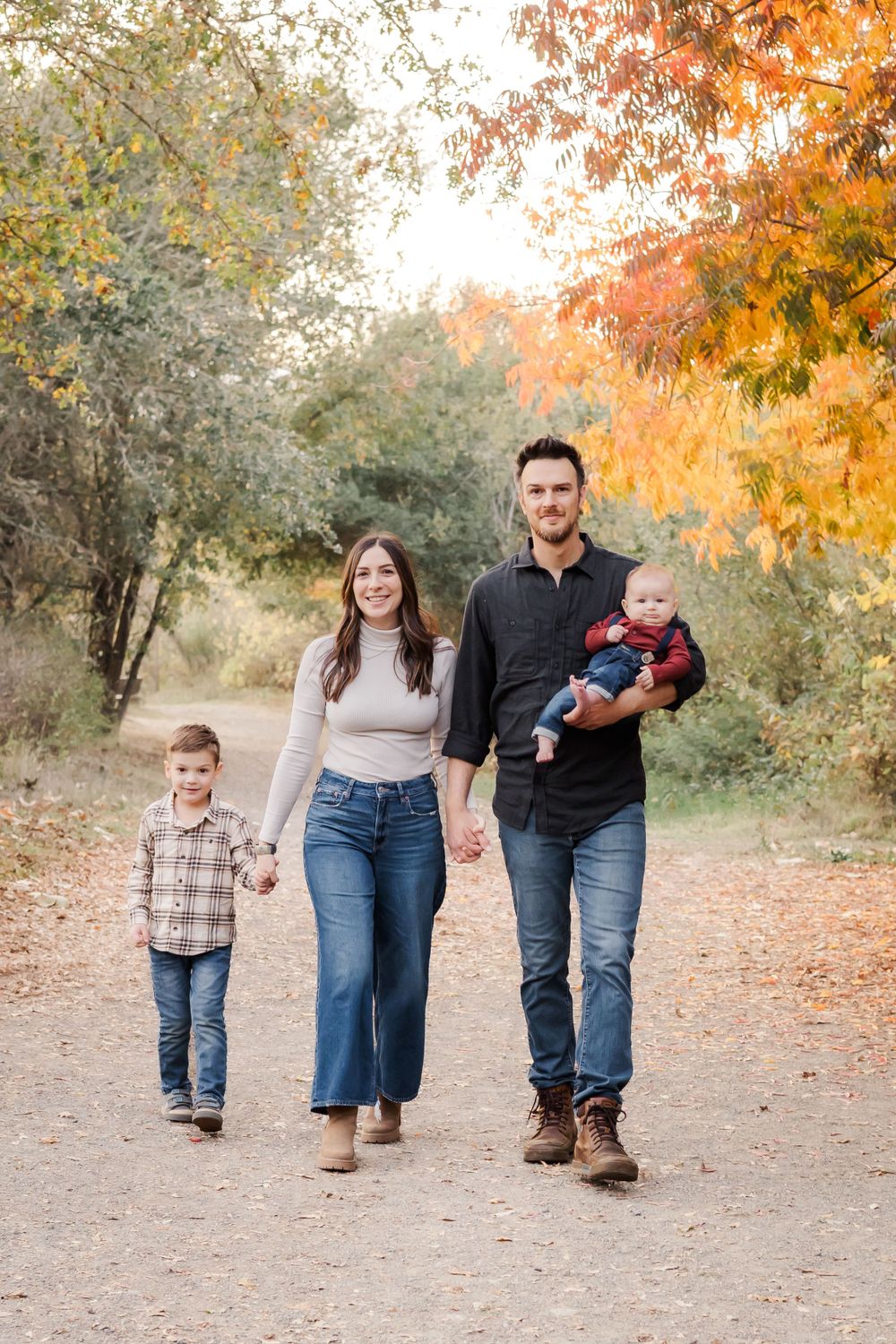 fall photos Sonoma County California. family walking and holding hands with their little kids. golden hour.