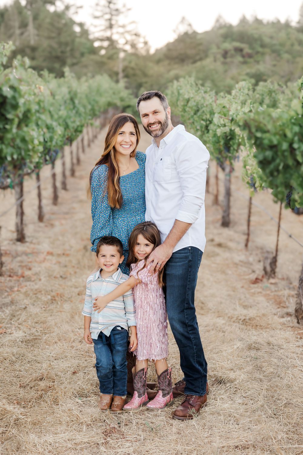 family standing in vineyard smiling. Sonoma County California mini session
