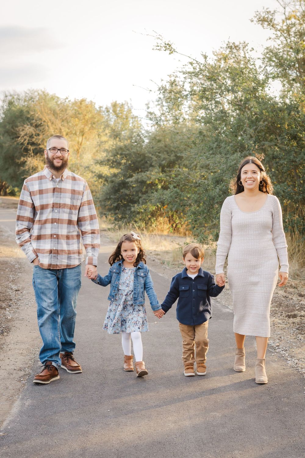 fall photos Sonoma County California. family walking and holding hands with their little kids. golden hour.