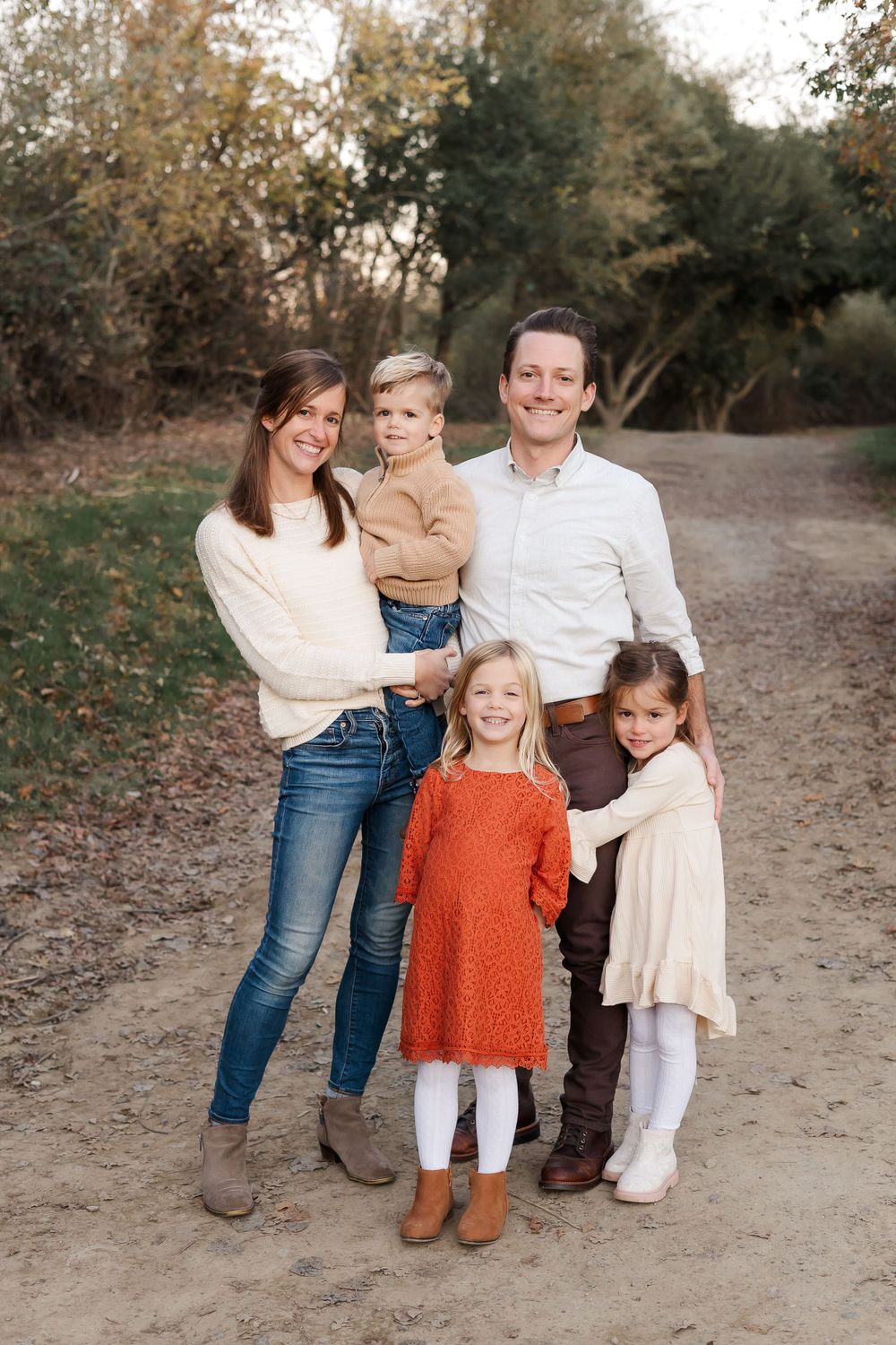 family of 5 standing together in a lush fall setting in Sonoma County, California for fall photos