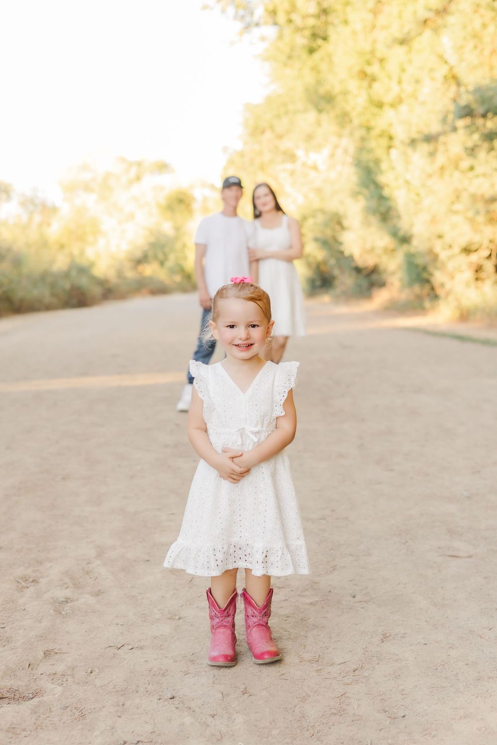 little girl with parents in a family session. riverfront regional park in Sonoma County. Healdsburg. light and airy.