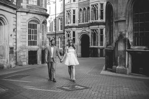 A black and white photo montage of historic European city streets showing architecture and pedestrians walking.