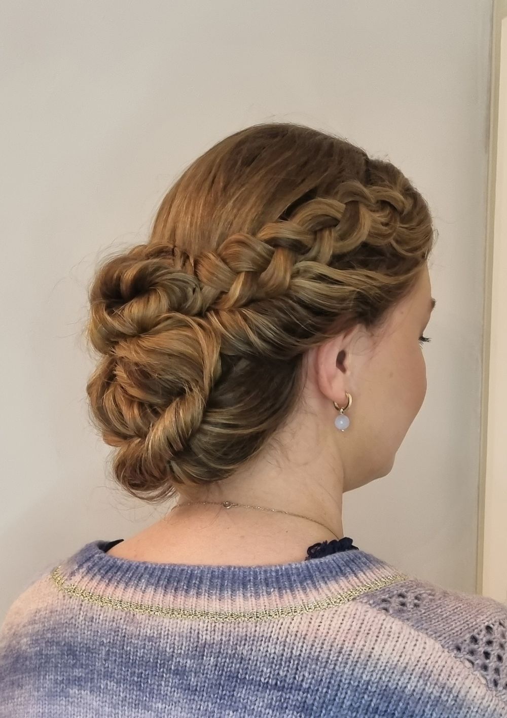 Side braids with large low twisted bun, no tendrils