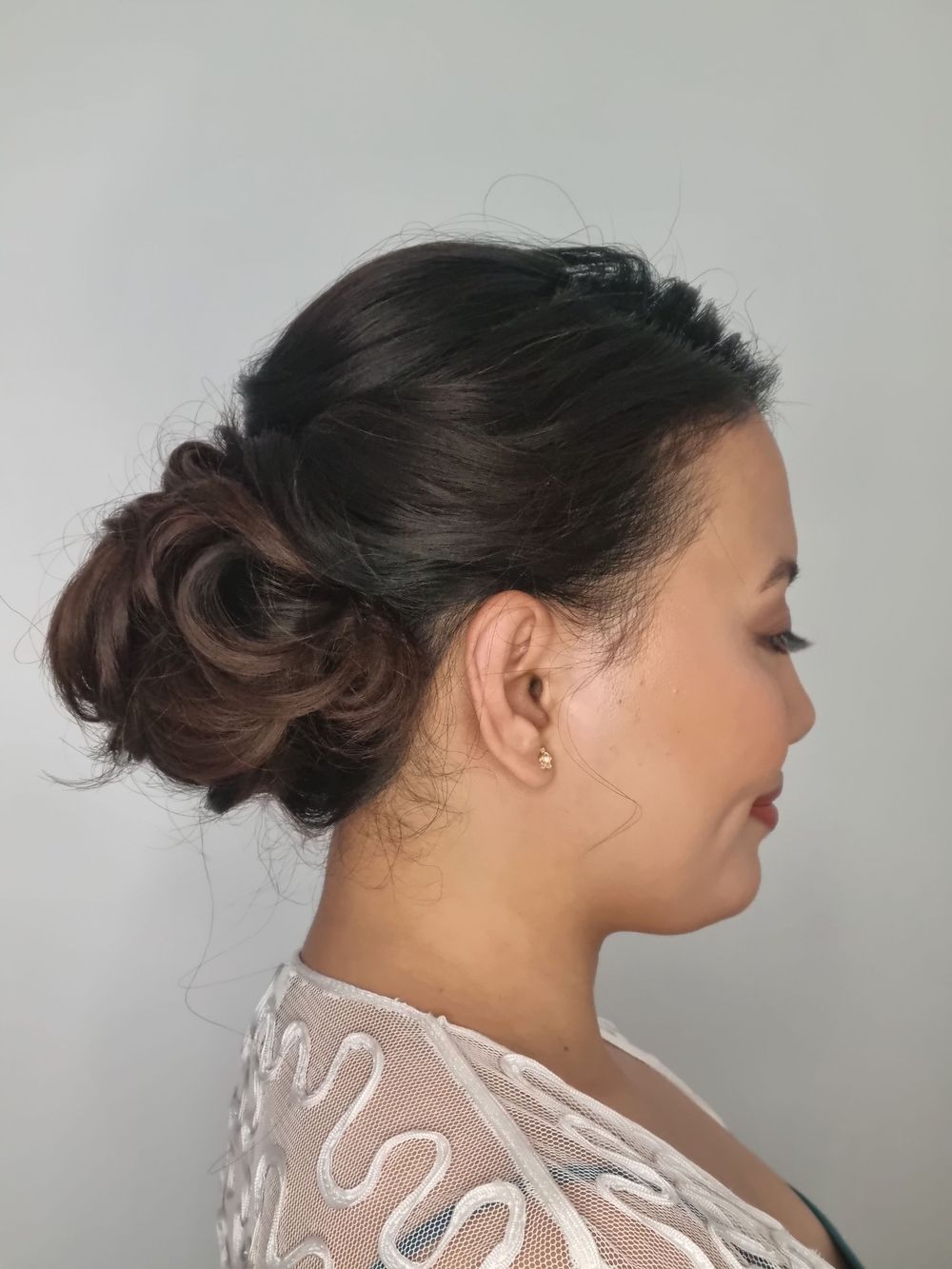 Side view of swirled low chignon bun