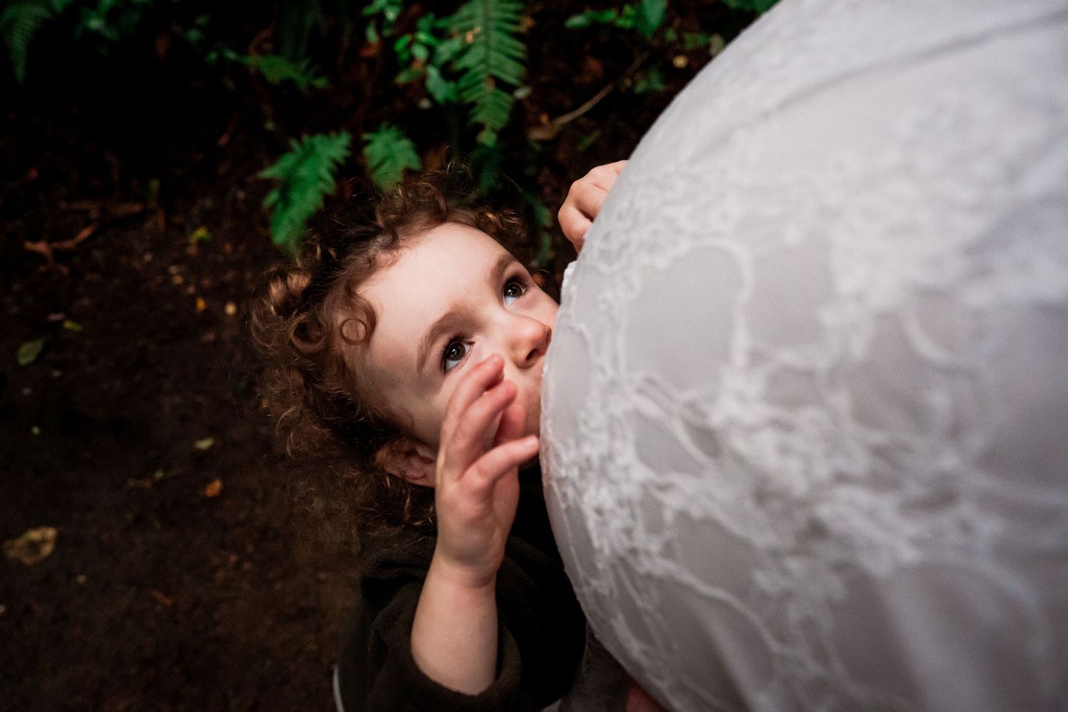 Child kissing mums baby bump at beautiful maternity session in Taranaki park, South Taranaki family photographer