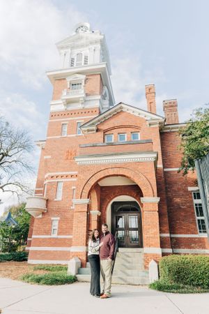 Historic brick clock tower building with white trim and arched entrance on sunny day in historic Lawrenceville Courthouse