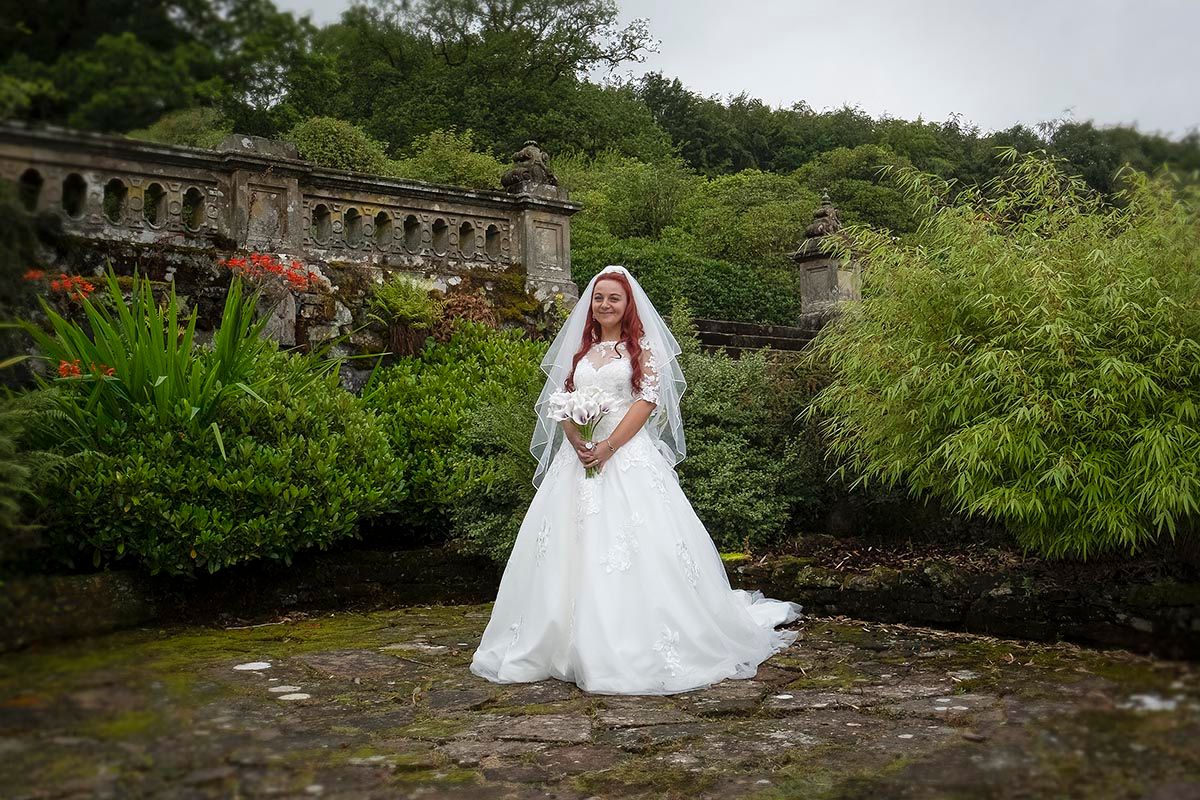 Bride holding her wedding bouquet in the gardens at Auchen Castle