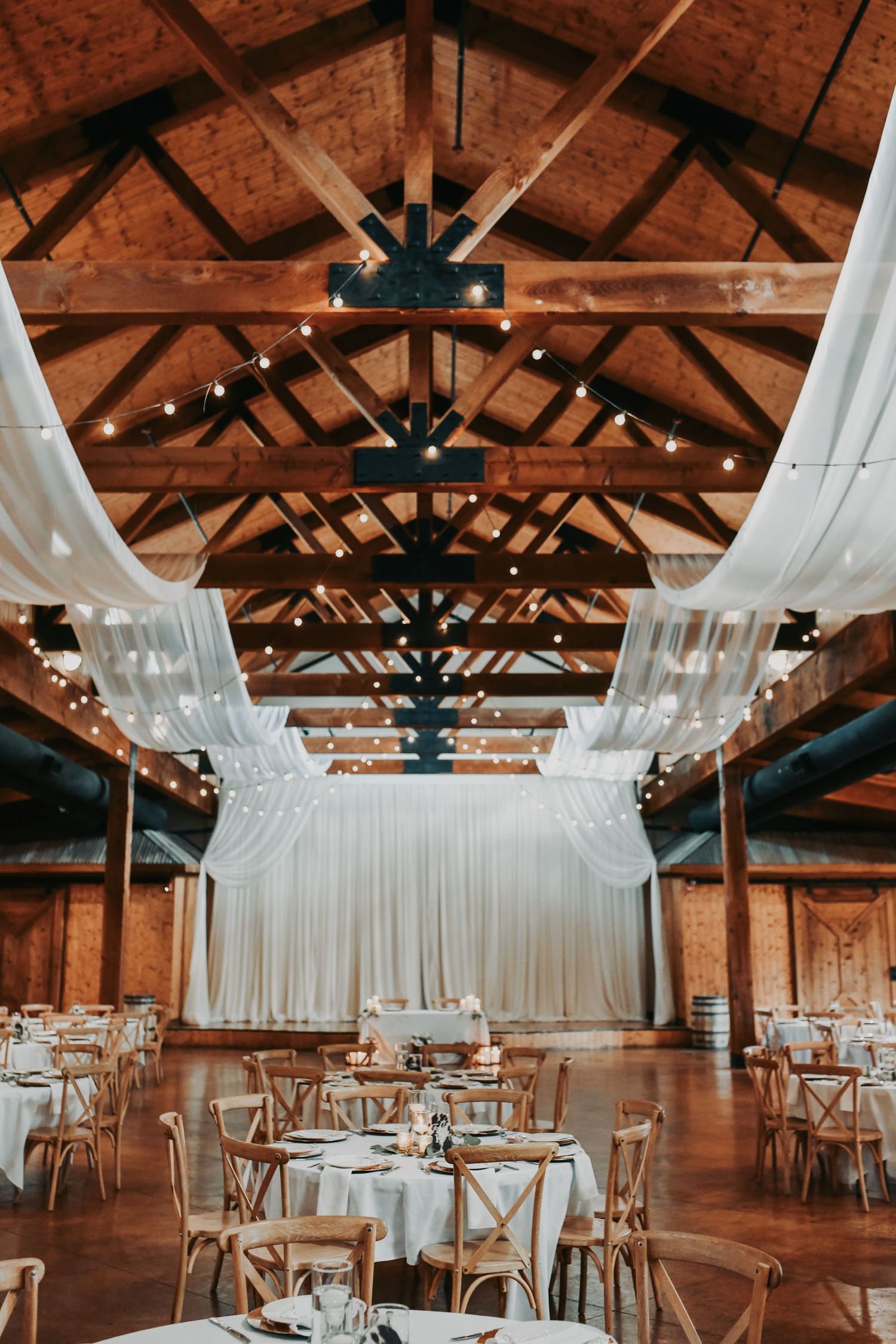 Elegant wedding reception details with gold accents and loose greenery at Lucky Spur Ranch