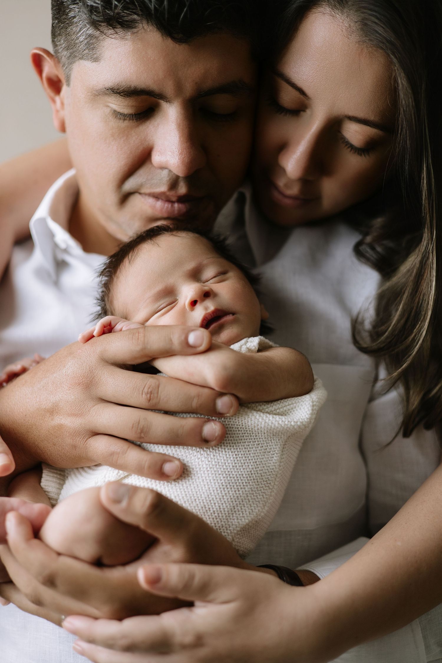 Newborn photography in Punta Cana featuring baby and parents. Emotional, intimate images that preserve early family moments.