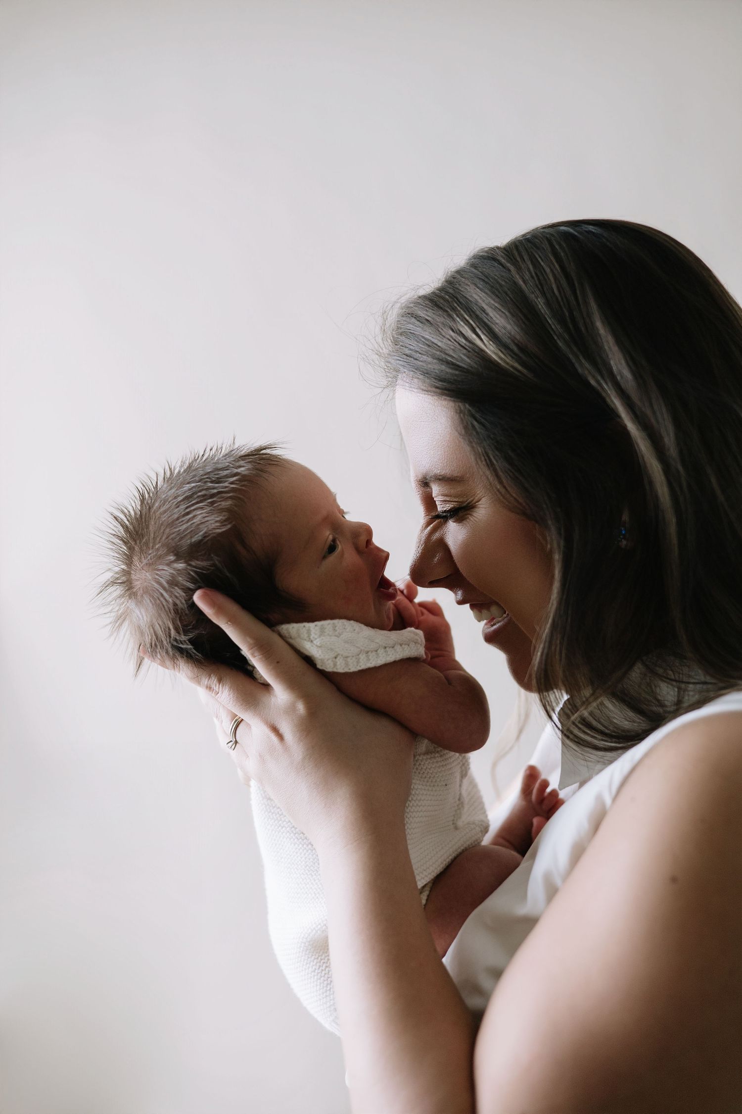Newborn portraits in Punta Cana highlighting baby alone and with parents. Warm, timeless images full of love and connection.