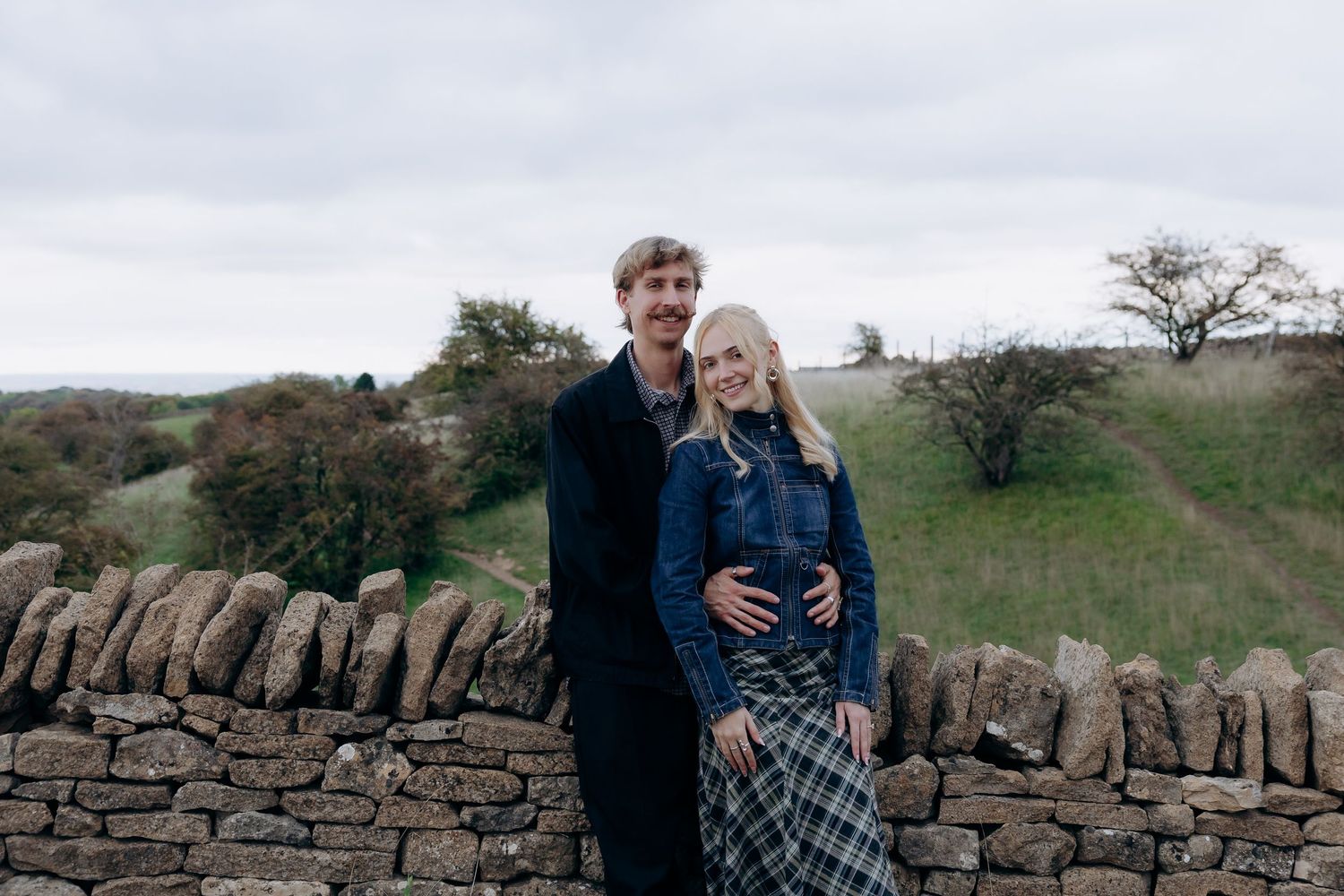 Couple celebrating their proposal at Broadway Tower.