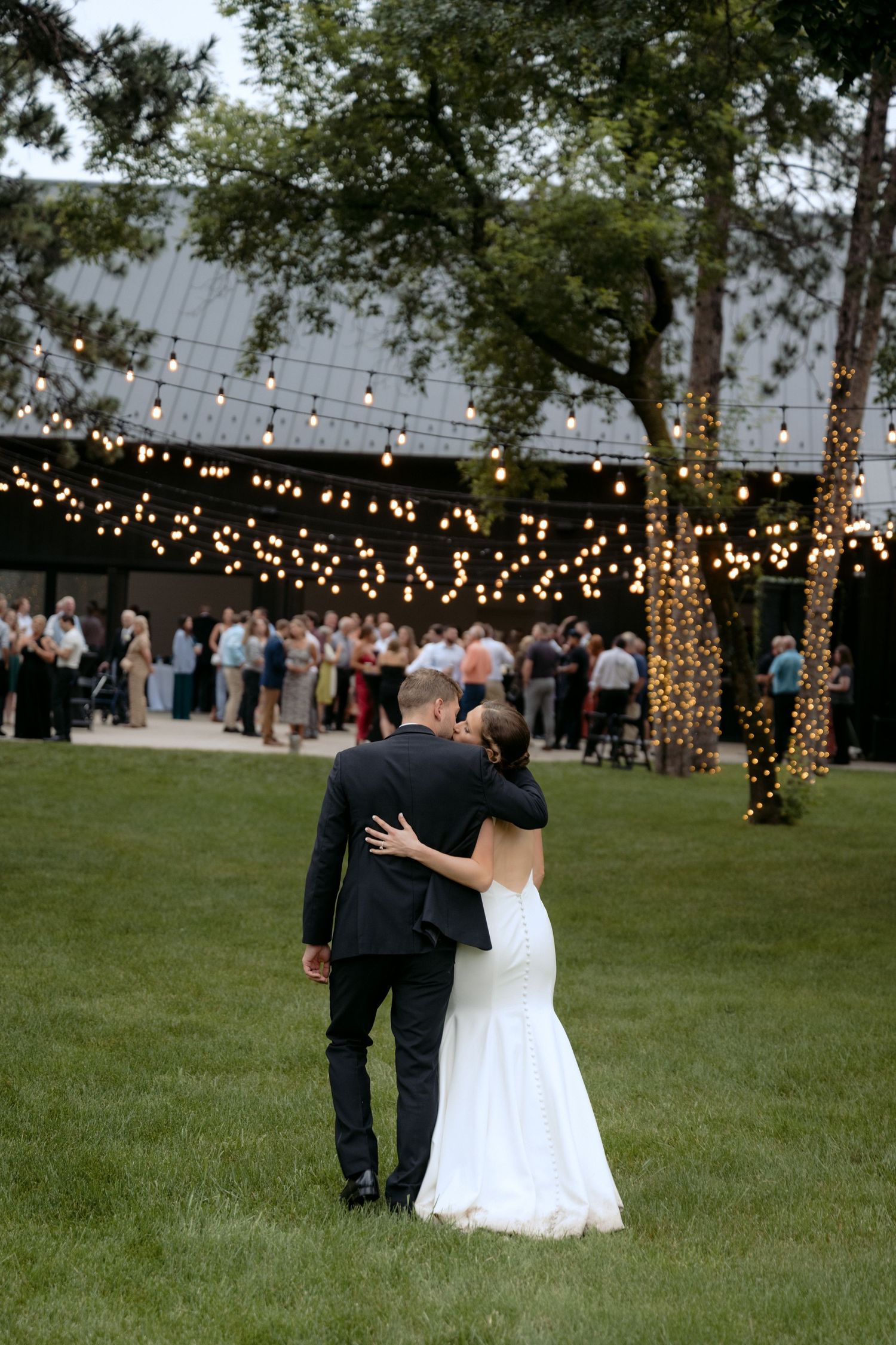 Bride & Groom kiss and walk towards their guests at La Pointe Events in Somerset, WI.
