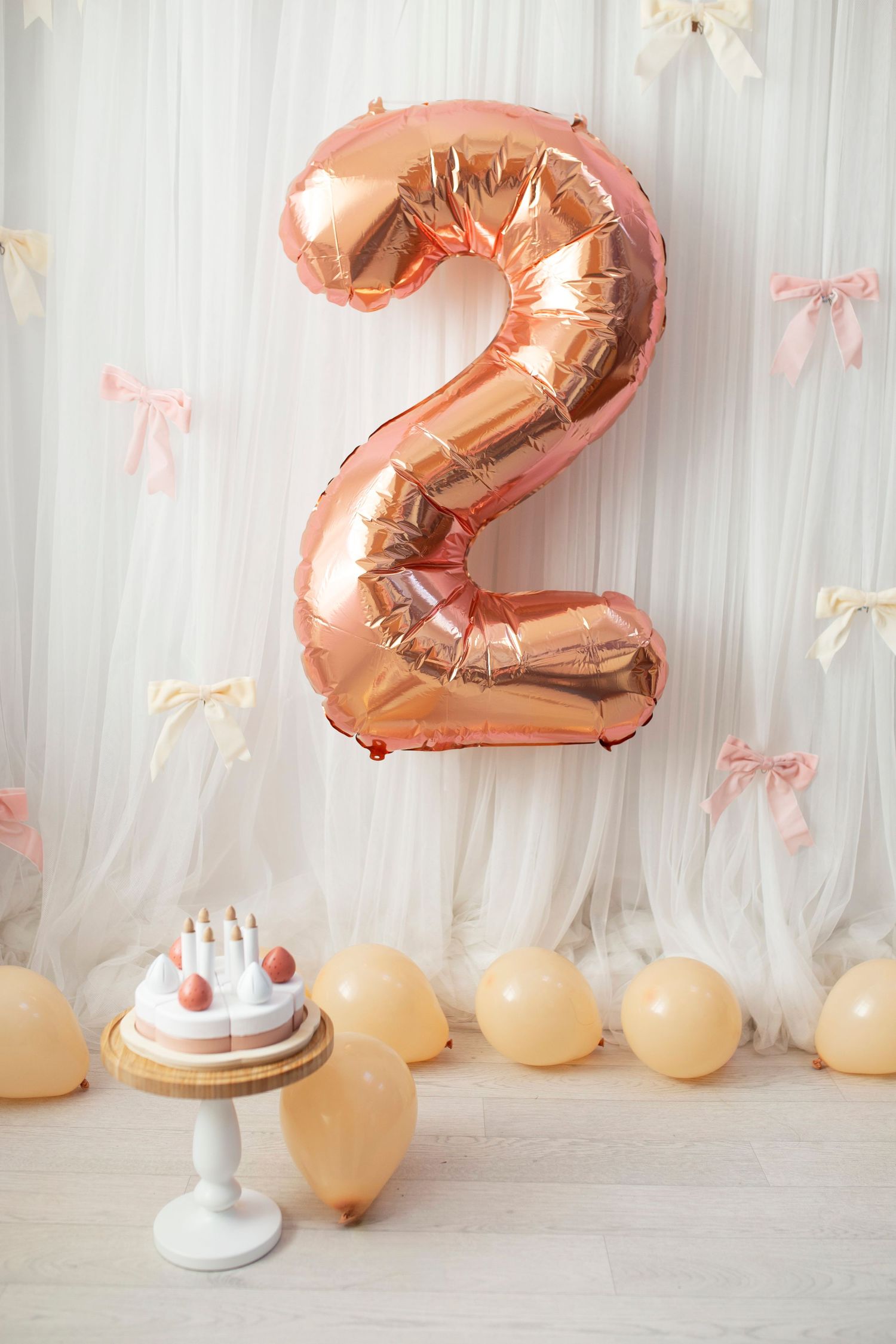 second birthday photoshoot set up featuring pink bows and balloons by little wonderland photography widnes cheshire