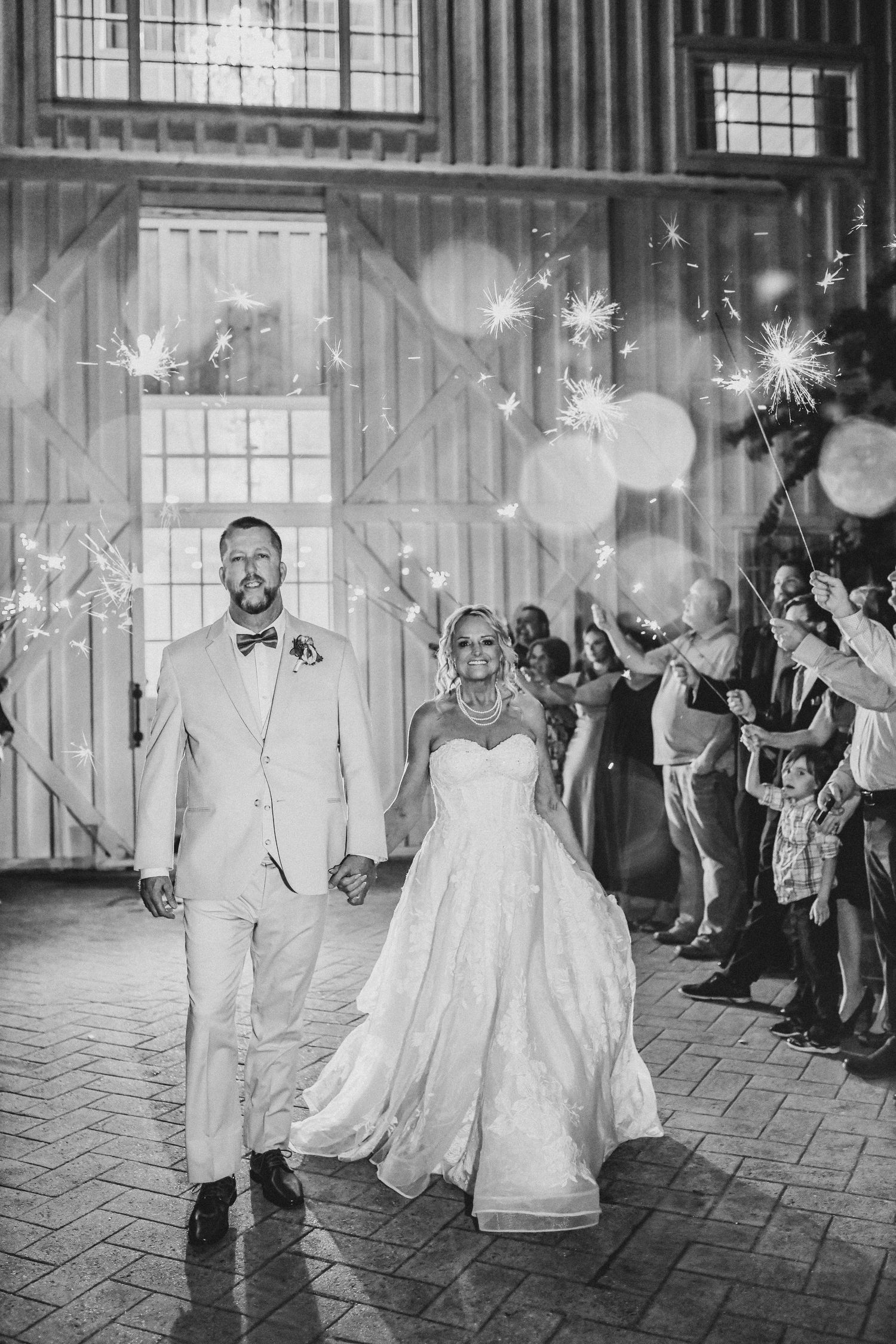 Bride and groom running through a sparkling sendoff at the end of their wedding night