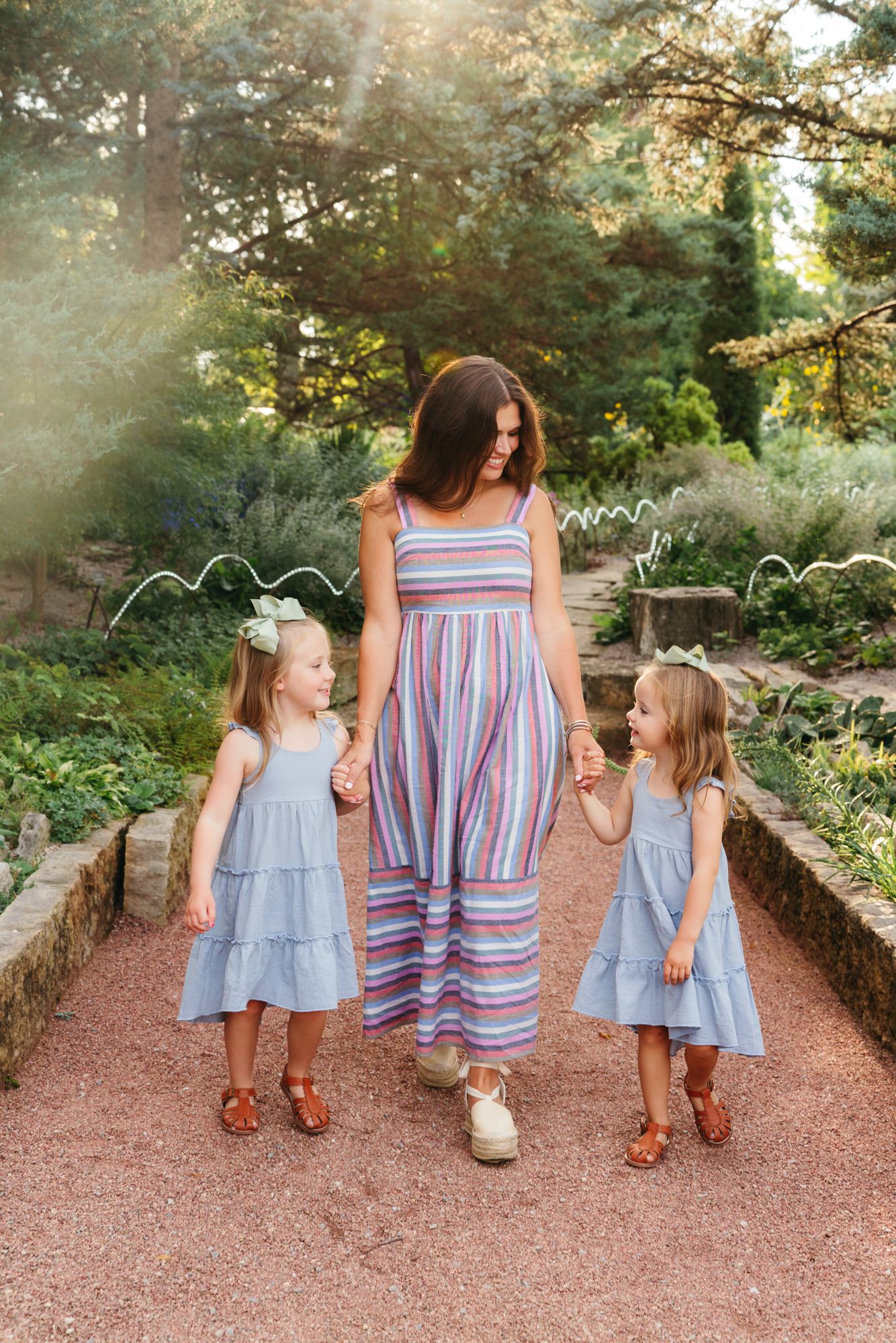 Photo of mother and two daughters walking
