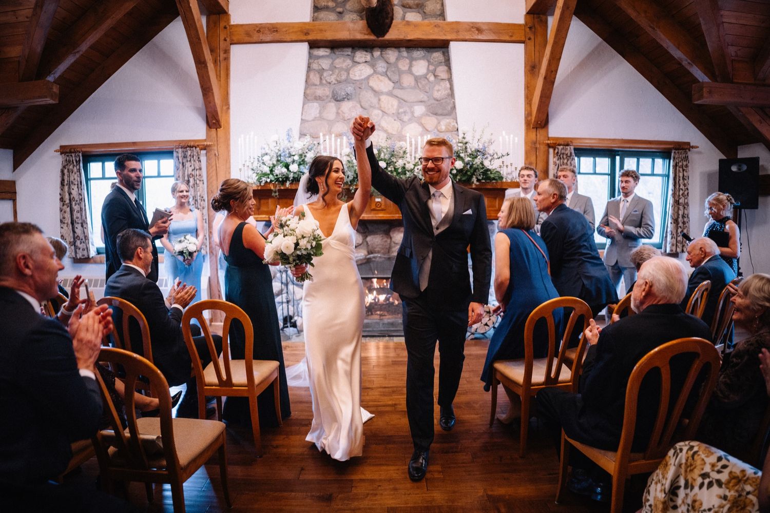 Bride and groom celebrating down the aisle at The Post Hotel, Lake Louise