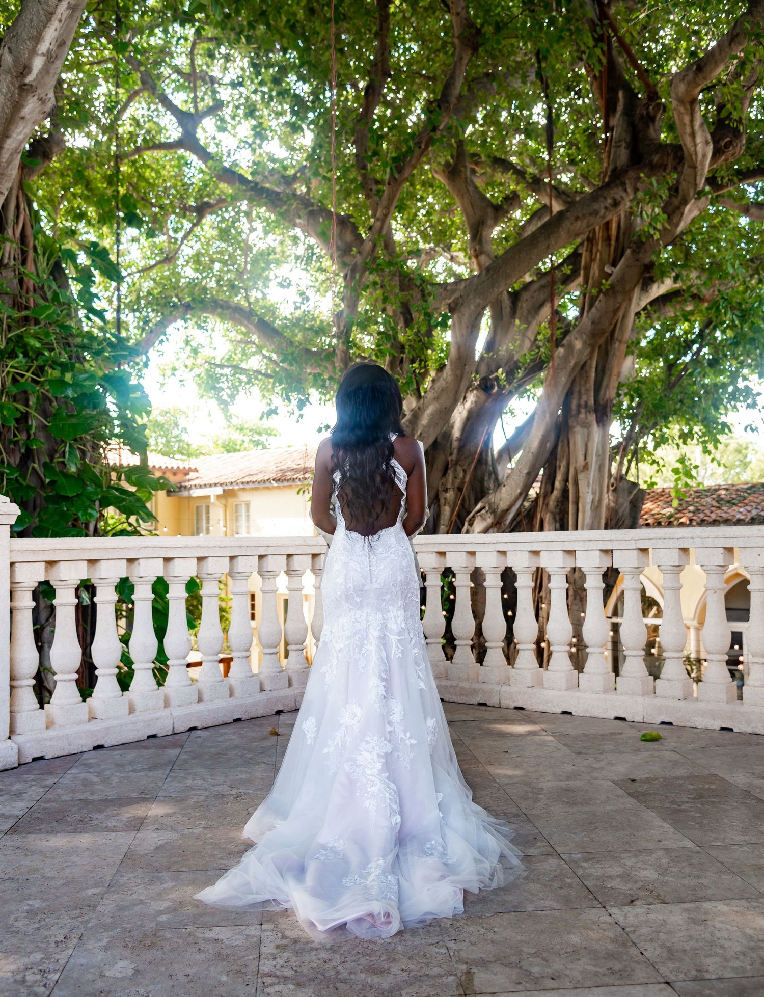 The Addison wedding photographers captured the back of the bride's wedding dress as she posed on the balcony.