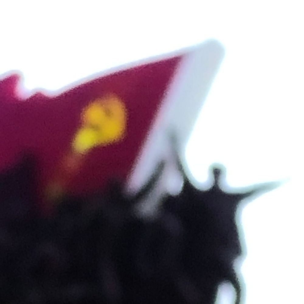 Blurred image of a red communist flag with yellow hammer and sickle symbol against a white background.