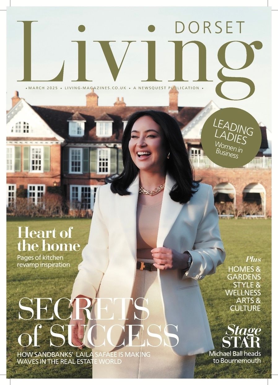 A lifestyle magazine cover for Dorset Living featuring a woman in a blazer standing in front of a stately brick mansion.