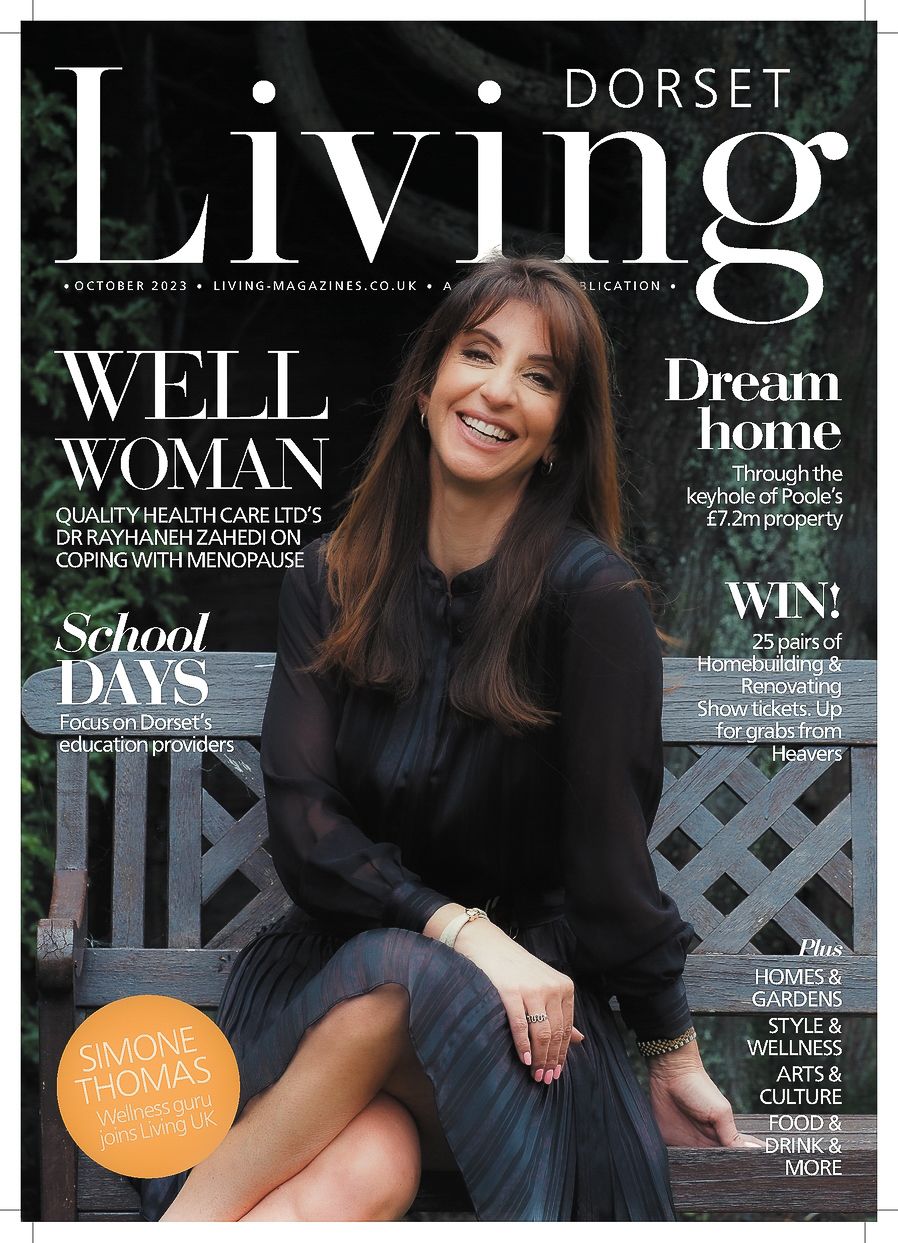 Cover of Dorset Living magazine featuring a woman in black sweater smiling against a dark background.