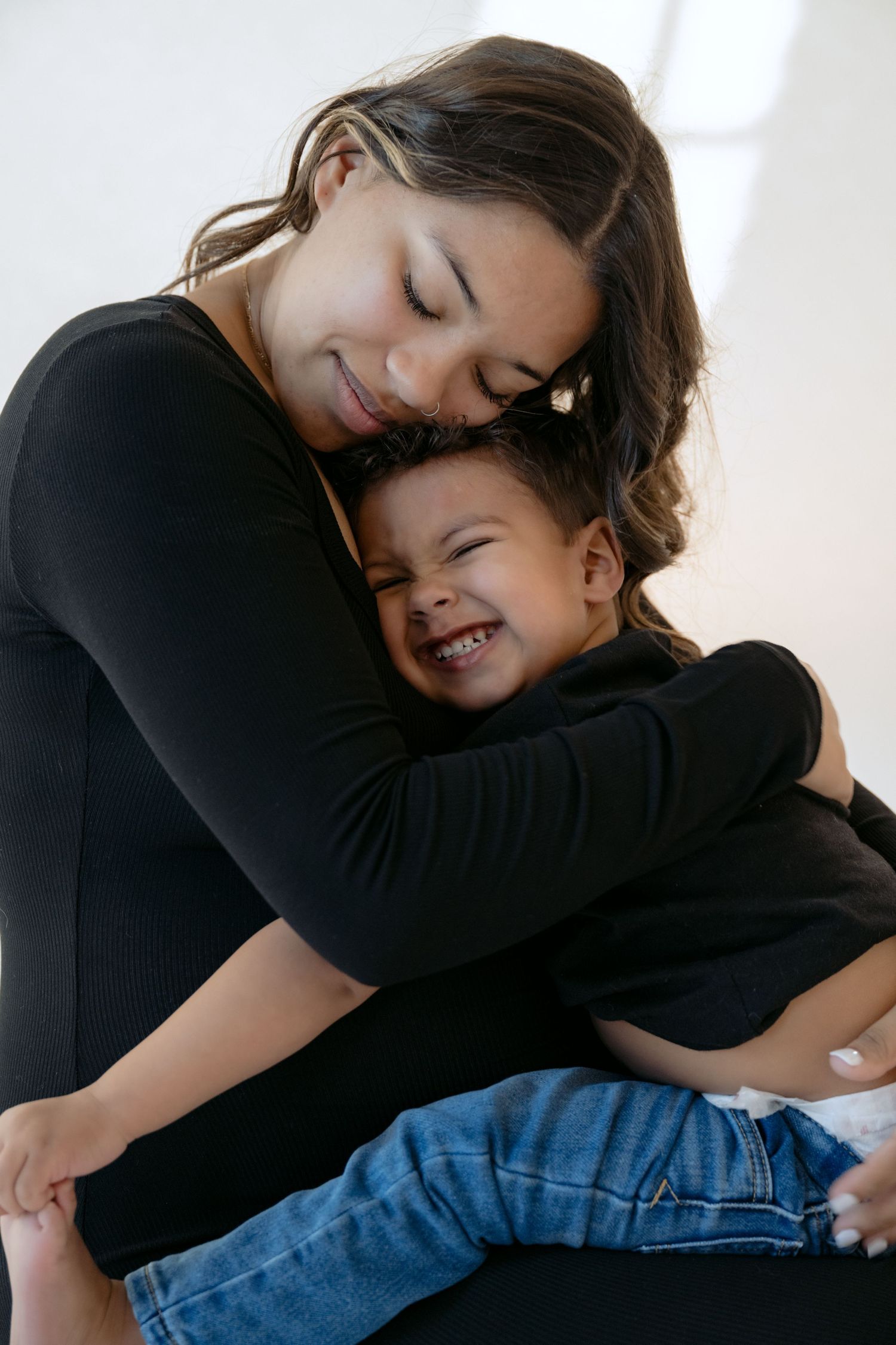 Mom hugs her son during in studio maternity session with Jagger Rose Photography in stillwater MN