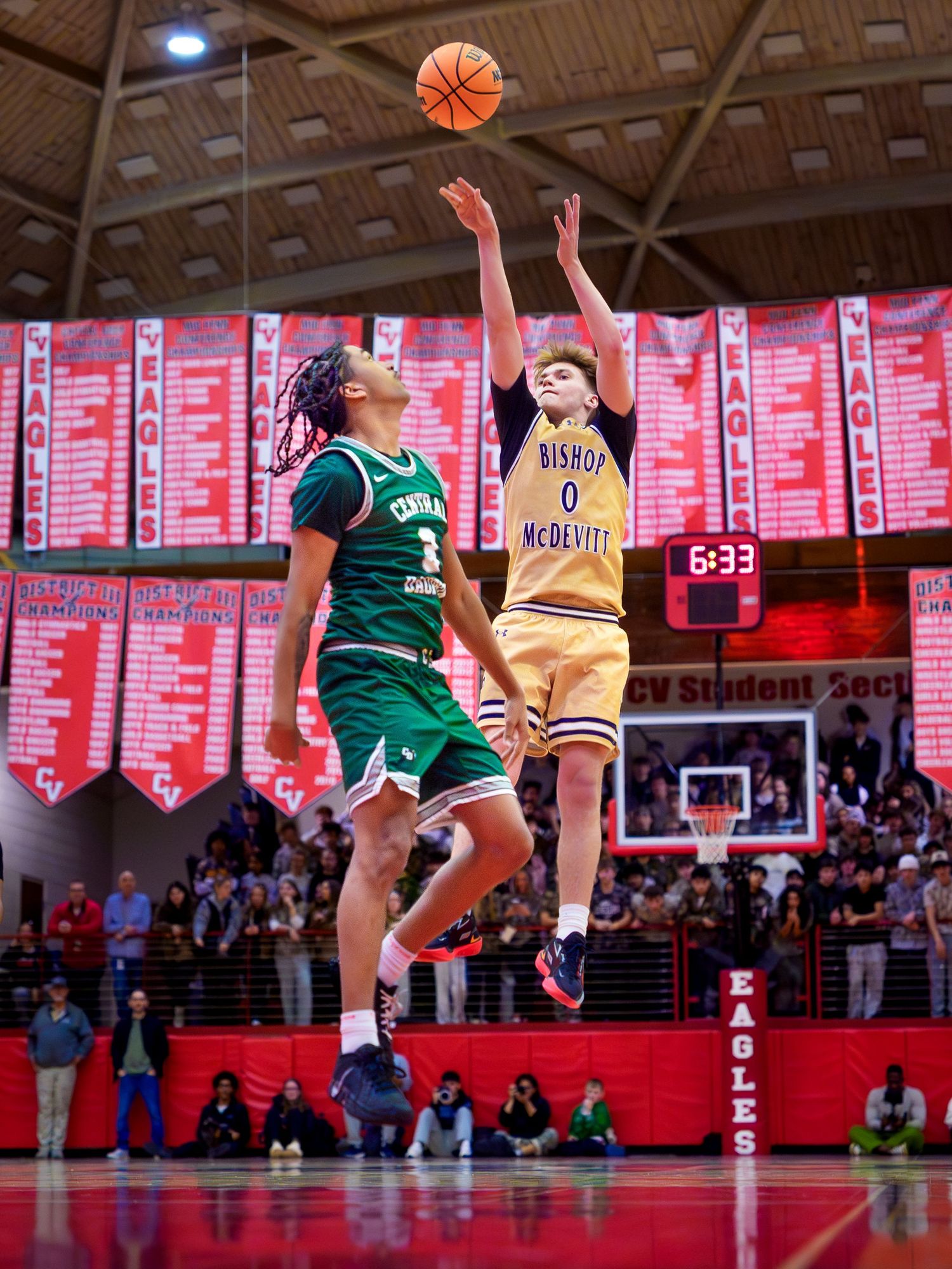 Bishop McDevitt player shooting over a Central Dauphin defender Mid-Penn championship, by Deanna Fox, SportsFox Photography based in Hershey