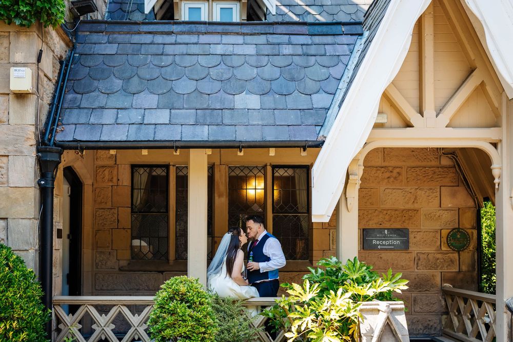 Couple sharing a silly moment at the building entrance on their wedding day at West Tower Exclusive Wedding Venue by Lynette Matthews Photo