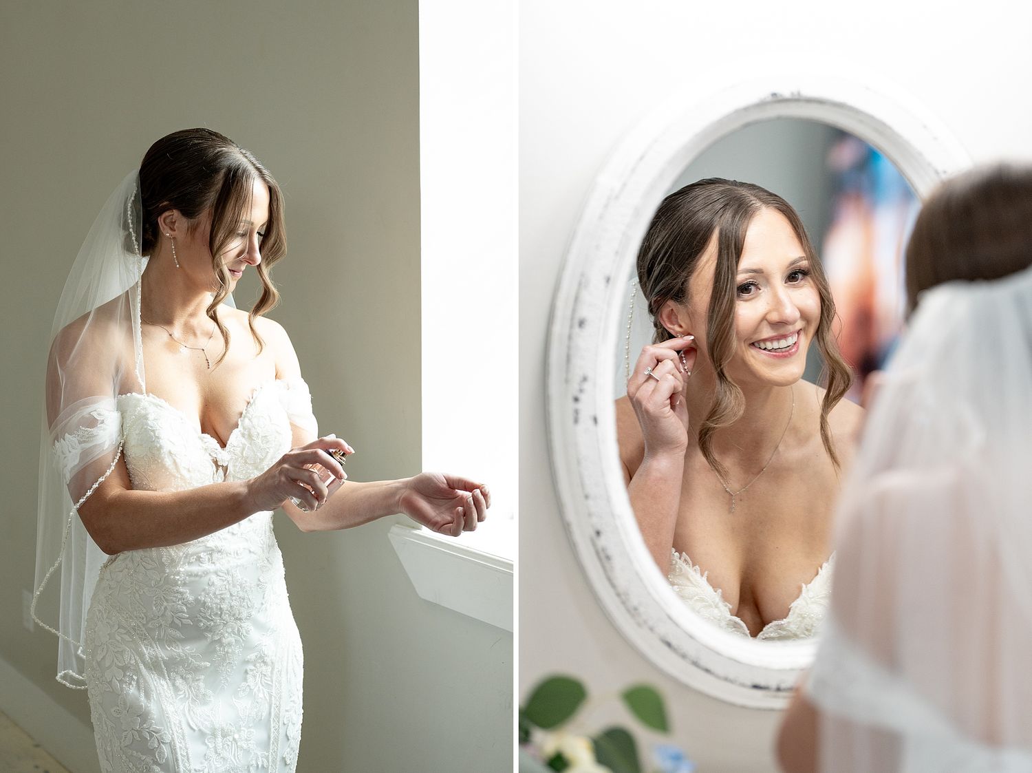 Bride in lace wedding dress and veil adjusting jewelry while smiling at her reflection in a white oval mirror.