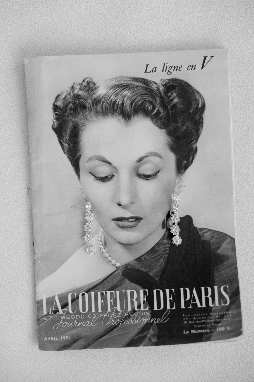 Vintage 1954 La Coiffure de Paris French professional hairdressing journal cover featuring elegant woman with styled updo.