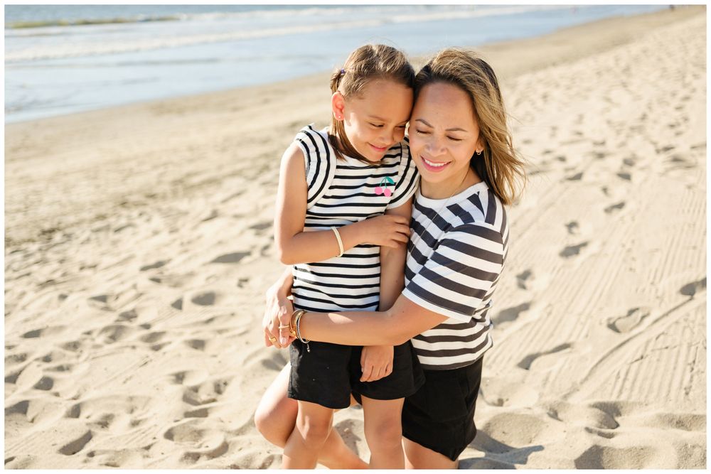 Mother and daughter embracing during a beach family session in Sayulita.