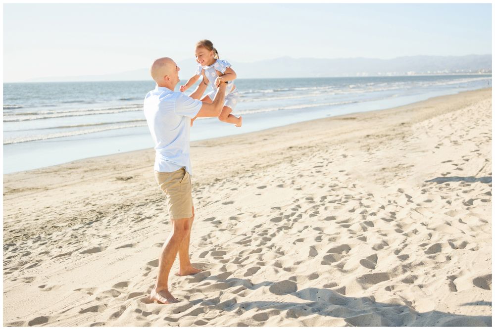 Father lifting his daughter during a family photo session in Sayulita.