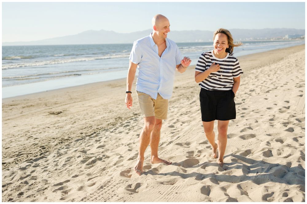 Parents walking together along the beach during a Punta Mita family session.
